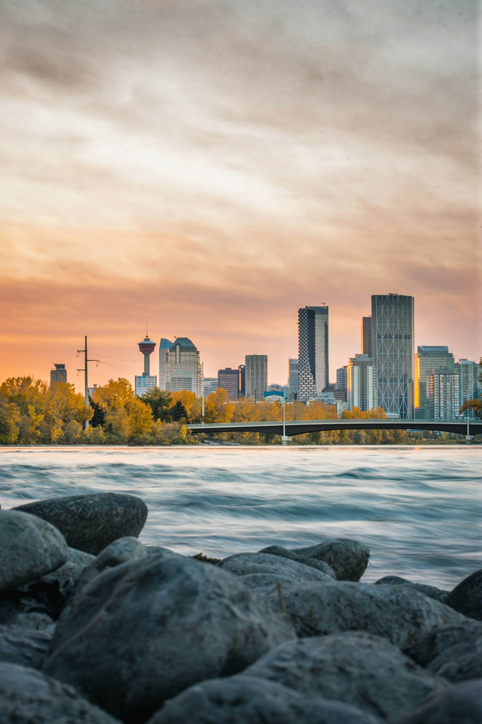 Calgary skyline at sunset above the Bow River