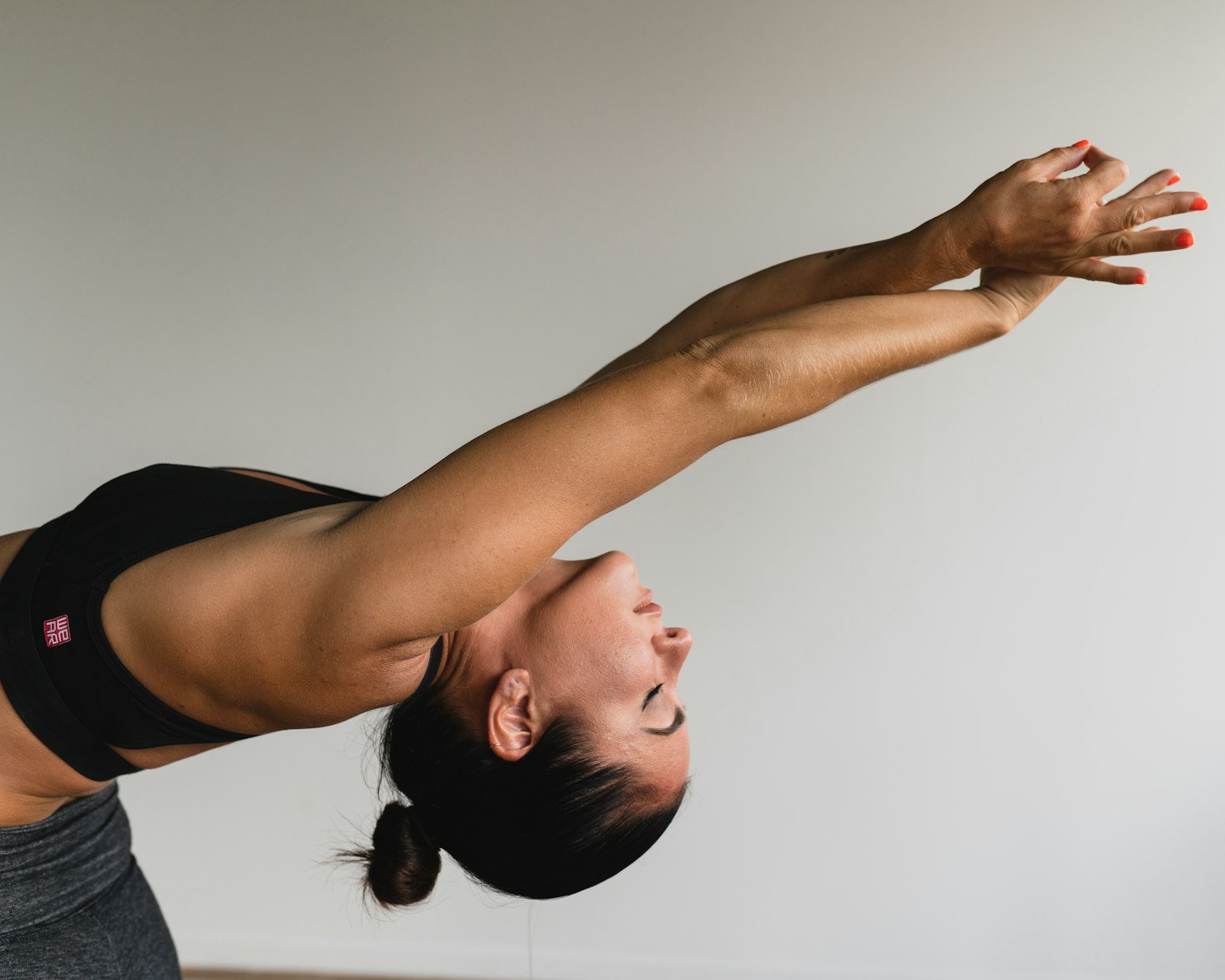 Woman doing a gentle side stretch, part of a home exercise programme